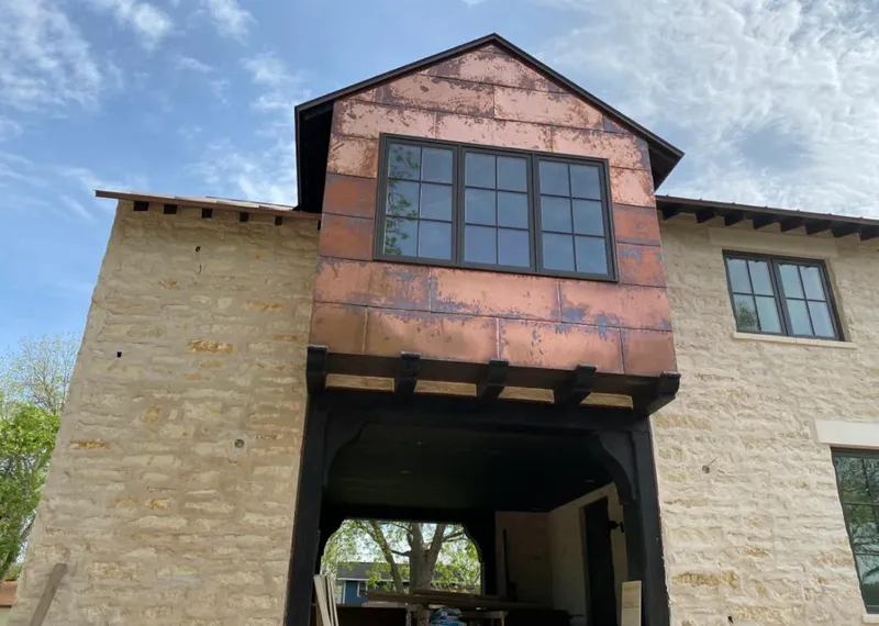 Copper metal panel facade on a stone building for Metal Roof Coating in Fort Worth